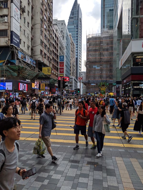 Bamboo scaffolding. A lot of individual air conditioners, not only on the walls, but also right in the windows, sometimes in old and historical buildings